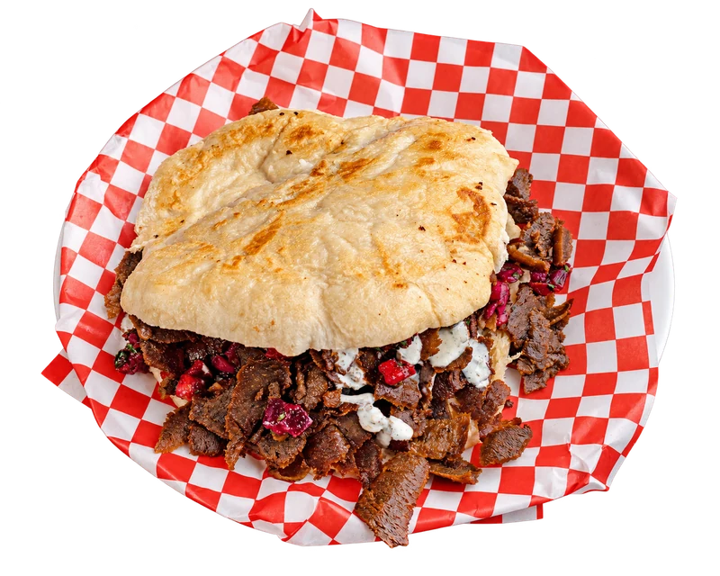 Beef doner in lepinja on red and white checkered paper